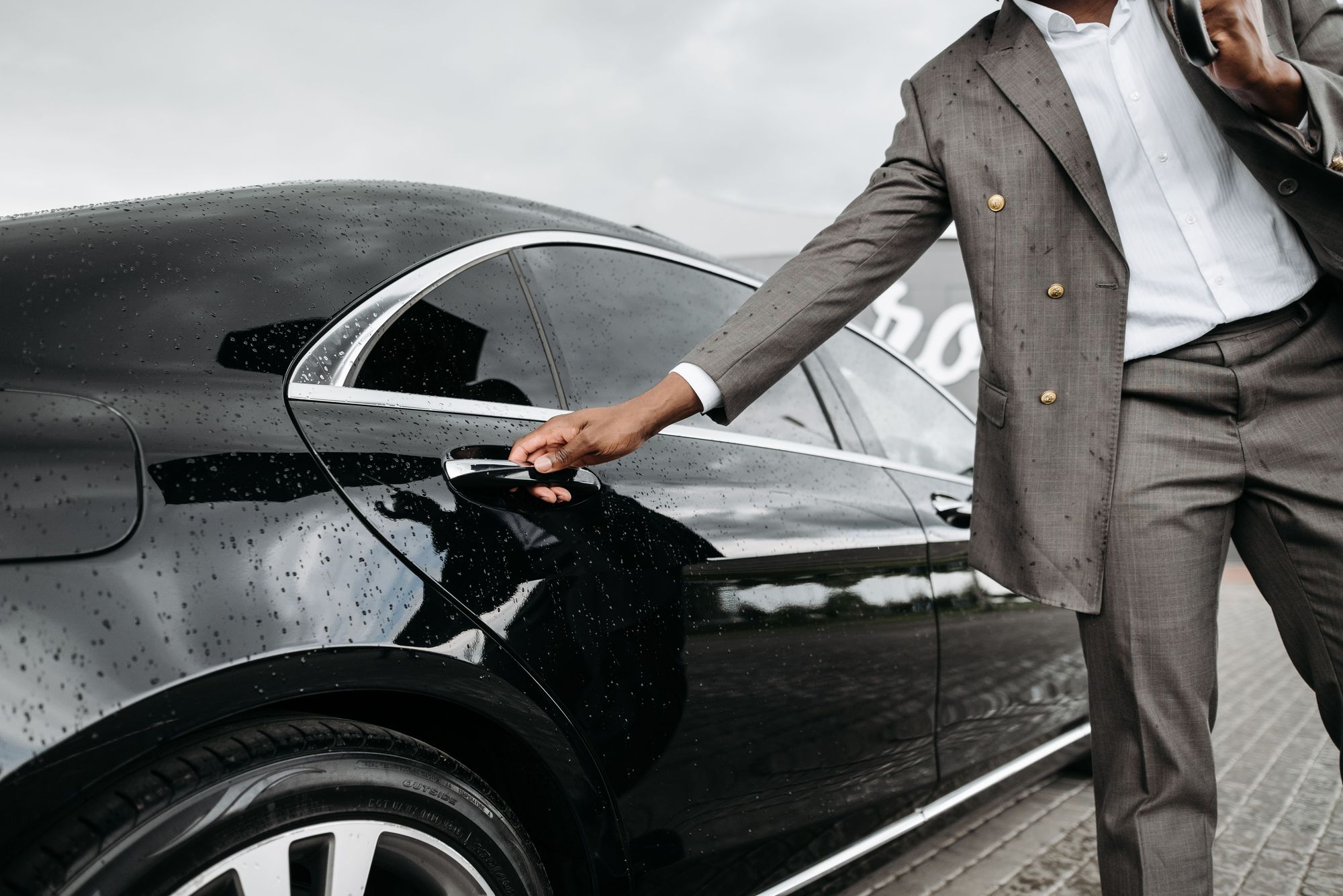 A chauffeur opening a car door