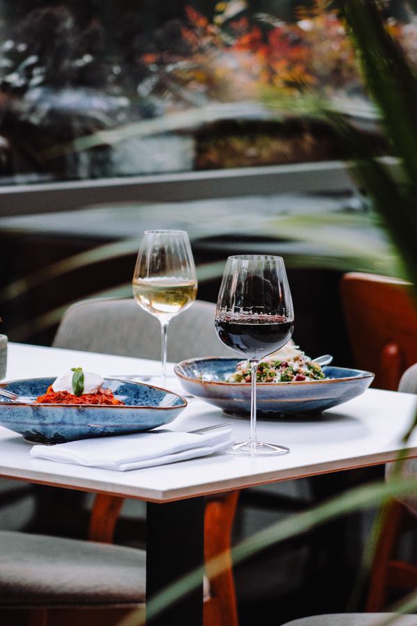 Wine glasses and shared plates at a long lunch